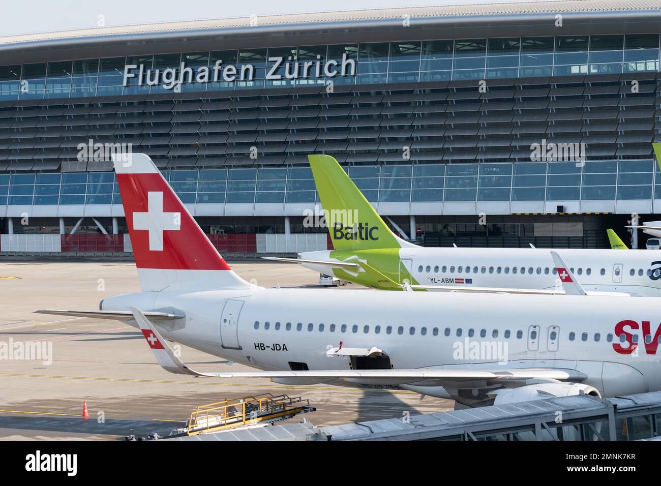 Zurich, Switzerland, January 19, 2023 Swiss Airbus A321-271N Neo and a Baltic Airways Bombardier CS-300 or A220 are parking at the gate Stock Photo