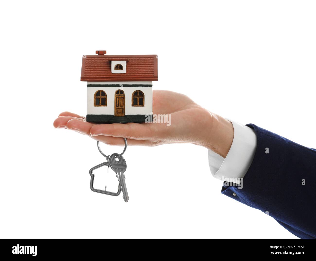 Real estate agent holding house model and key on white background ...