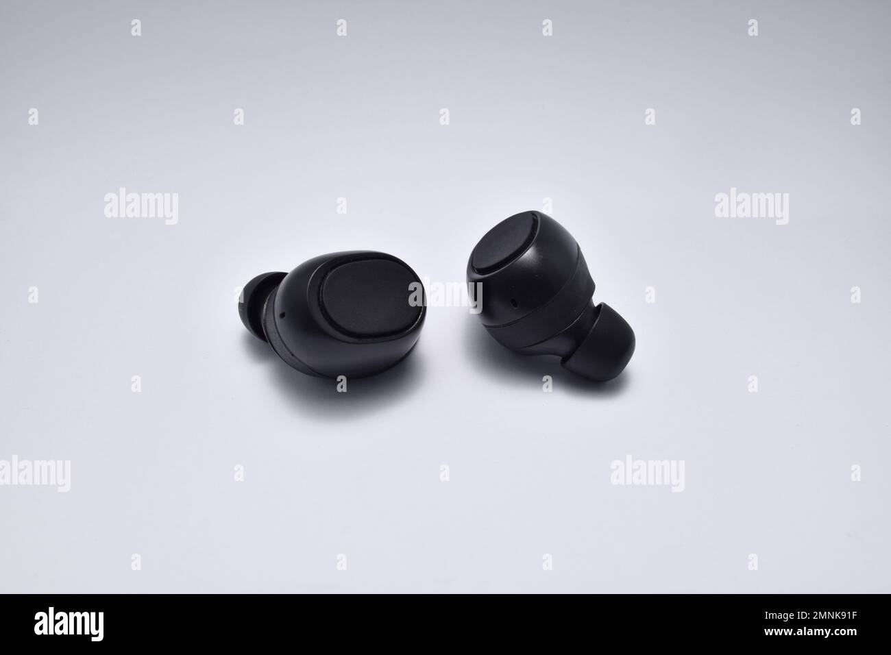 True Wireless Earphone bluetooth voice control isolated on white background. Stock Photo