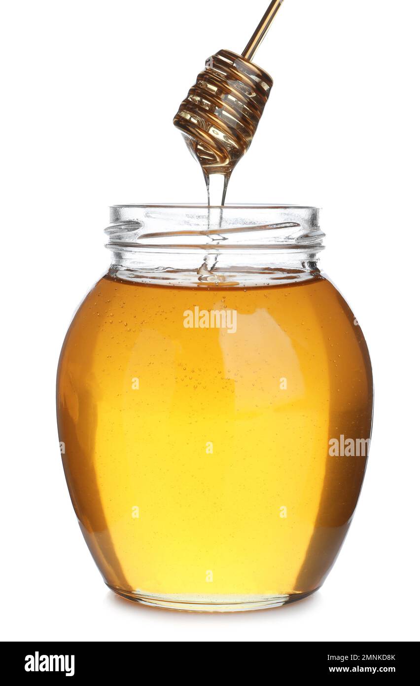 Honey dripping from dipper into jar isolated on white Stock Photo - Alamy
