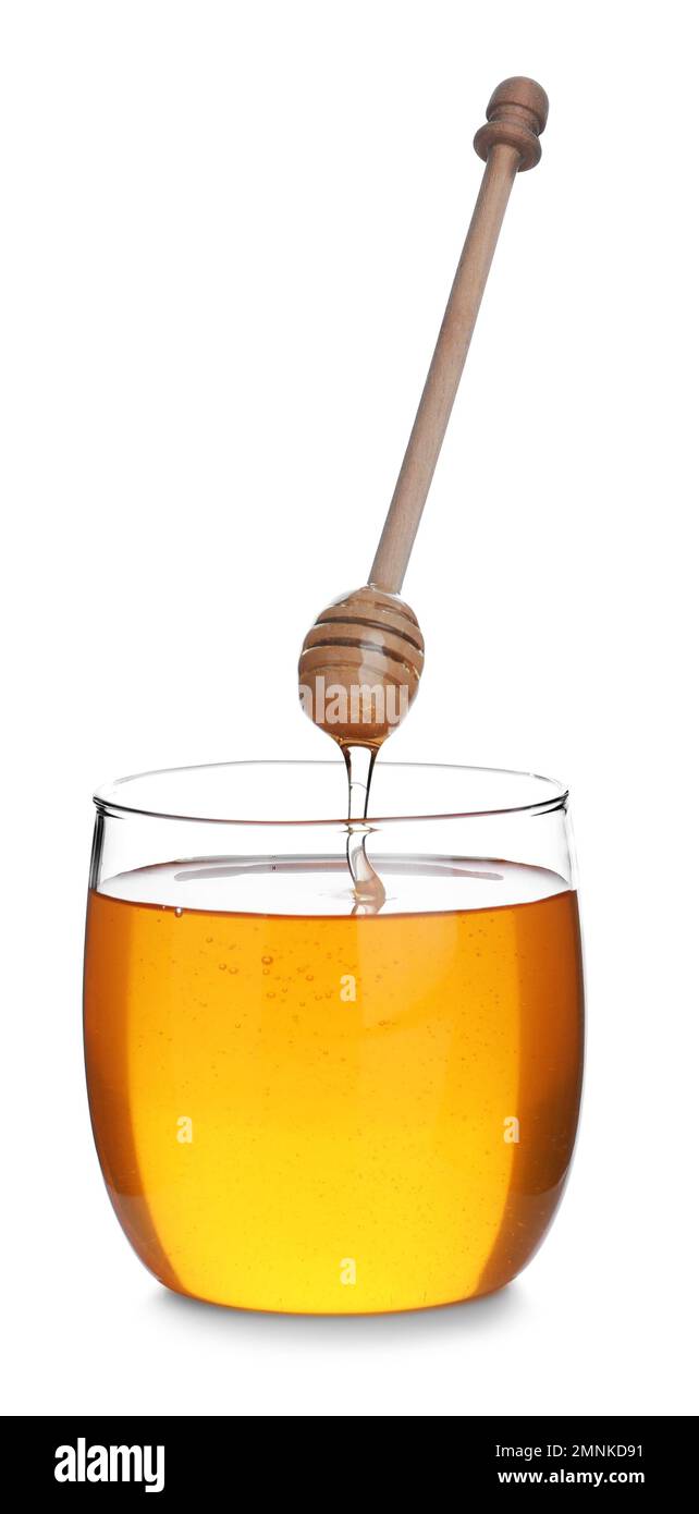 Honey dripping from wooden dipper into jar isolated on white Stock ...