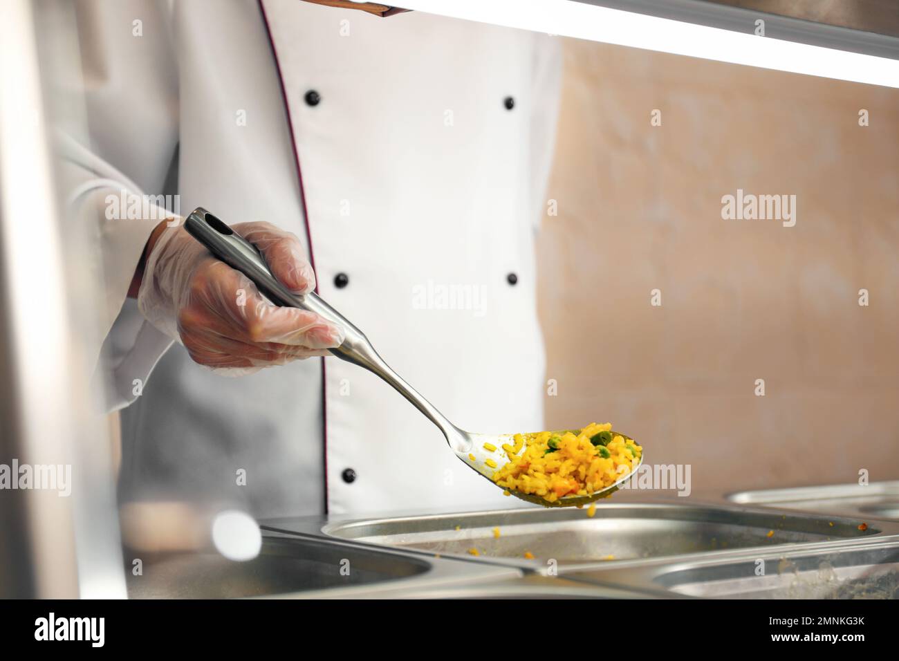 School canteen worker at serving line, closeup. Tasty food Stock Photo