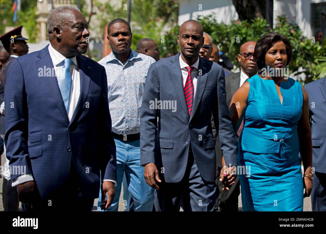 Haiti's President Jovenel Moise, center, walks with first lady Martine Moise and his Defense Minister Herve Denis, left, during a ceremony presenting the leadership of the newly reinstated Haitian Armed Forces (FAd'h) in Port-au-Prince, Haiti, Tuesday, March 27, 2018. Haiti has revived its military force decades after a national army was disbanded, and after U.N. military peacekeepers exited this Caribbean nation in 2017. (AP Photo/Dieu Nalio Chery) Stock Photo