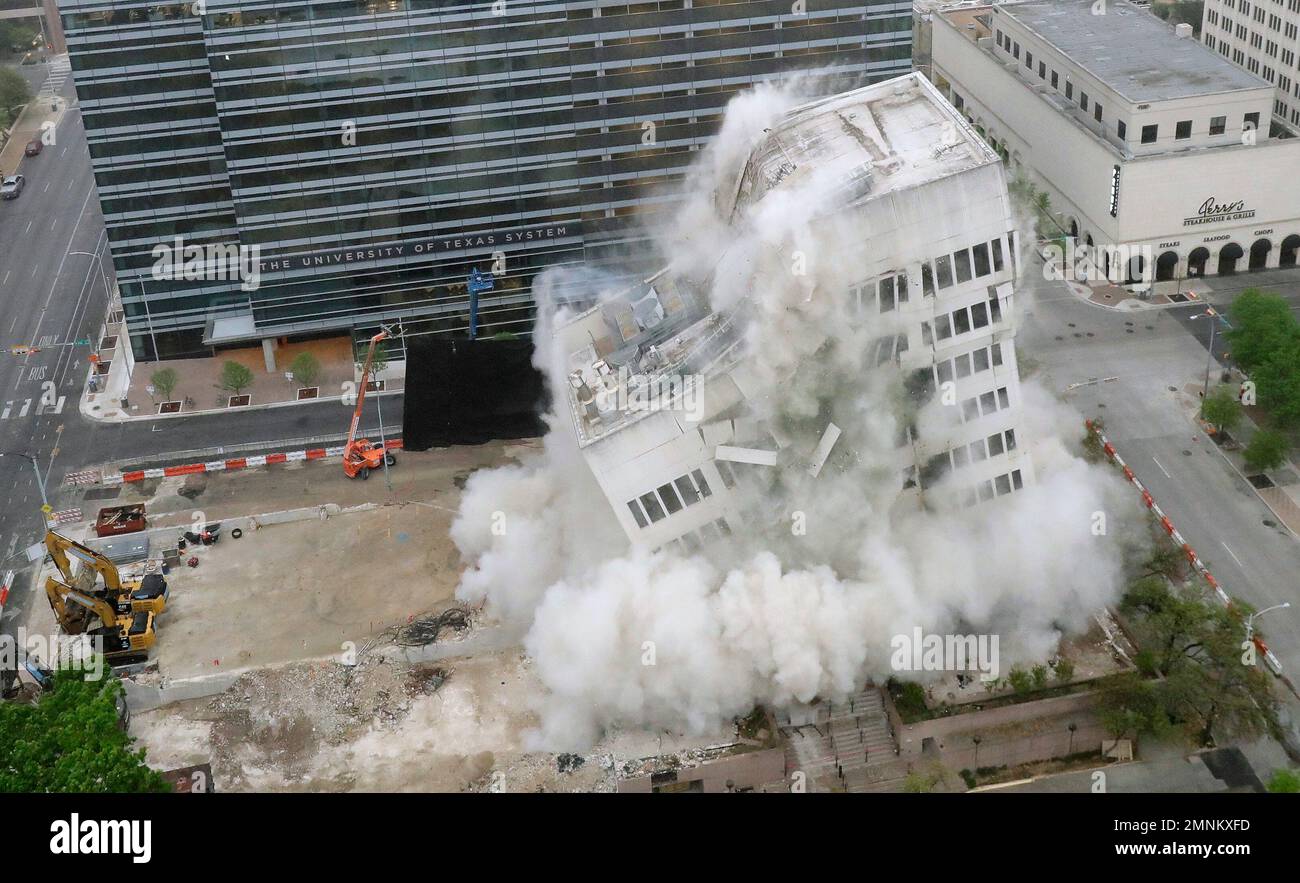 Ashbel Smith Hall, a nine-story University of Texas System building, is  imploded Sunday, March 25, 2018, in downtown Austin, Texas. The building  was demolished to make room for an office and retail