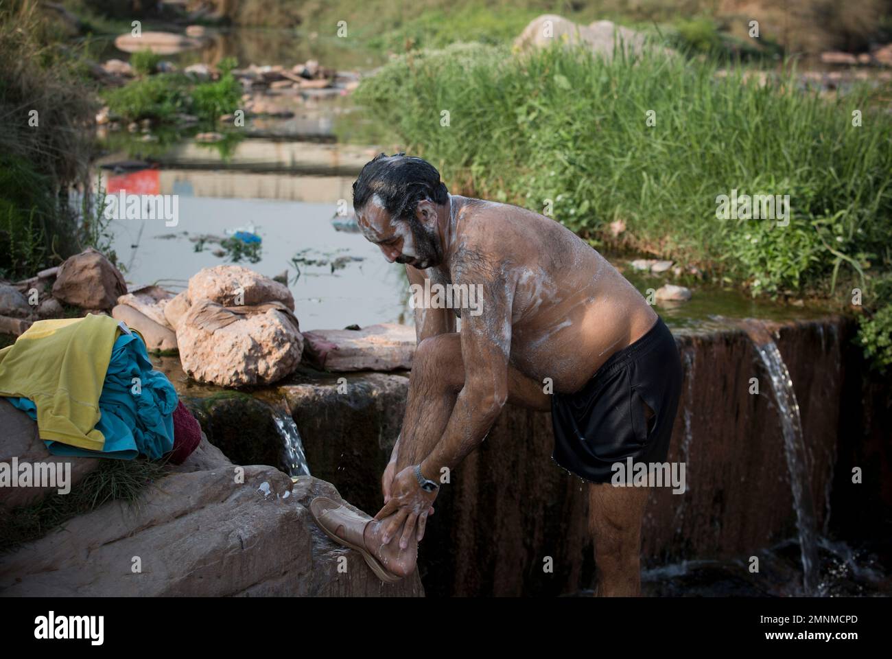 Water Laborer A Pakistani laborer takes a bath in a polluted stream on World Water ...