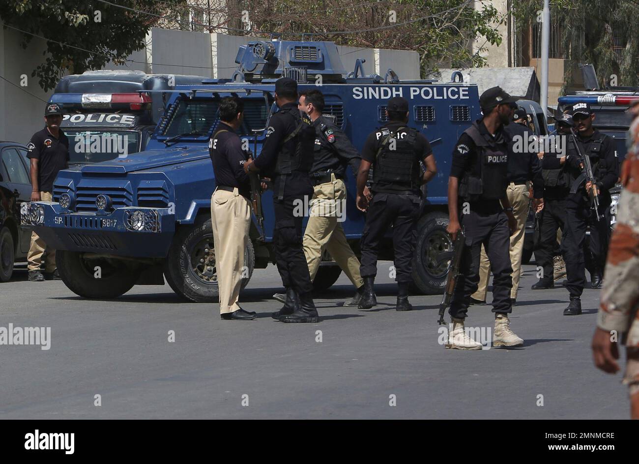 Pakistani police commandos escort an armored vehicle carrying Rao Anwar