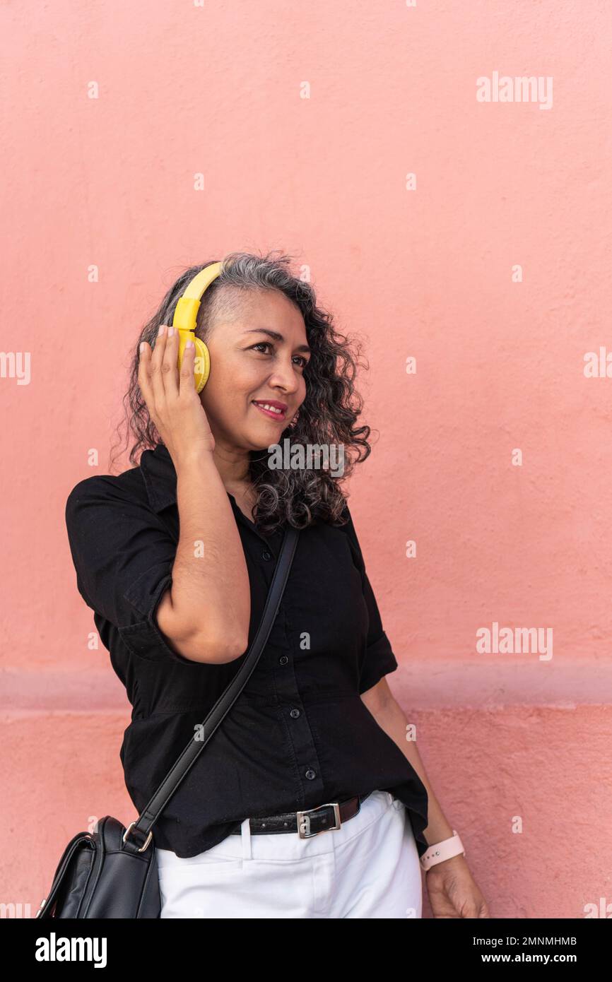 Mature woman dancing headphones hi-res stock photography and images - Alamy