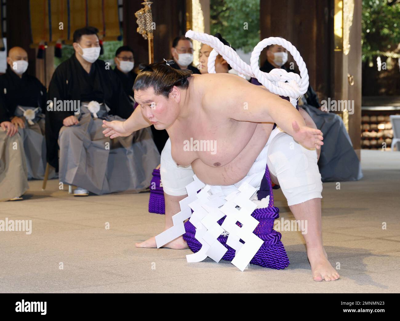 Sumo grand champion Terunofuji (C) performs a ring-entering ritual at ...