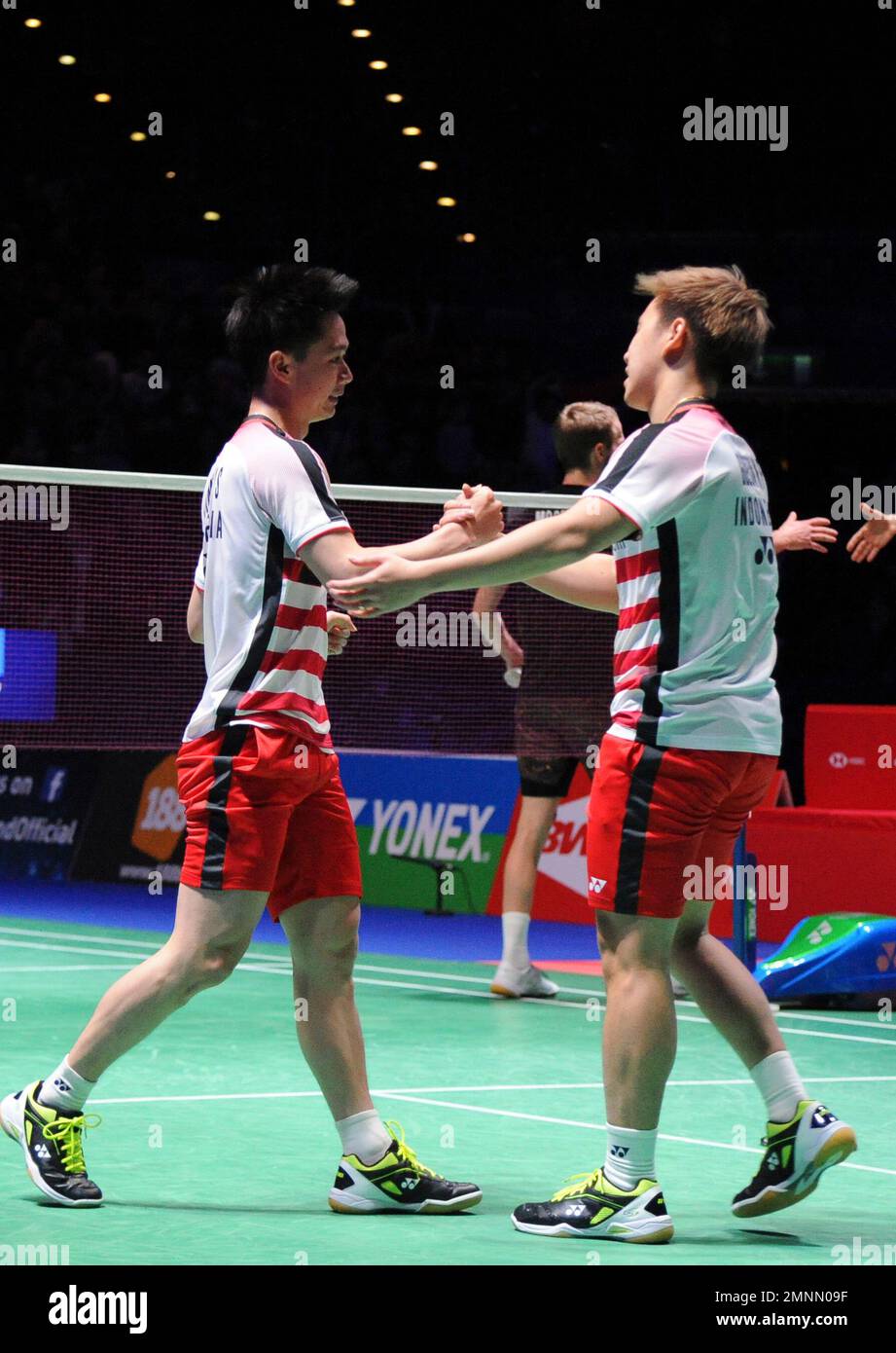 Indonesias Marcus Fernaldi Gideon and Kevin Sanjaya Sukamuljo, left, celebrate after defeating Denmarks Mathias Boe and Carsten Mogensen in the mens doubles final match at the All England Open Badminton tournament in