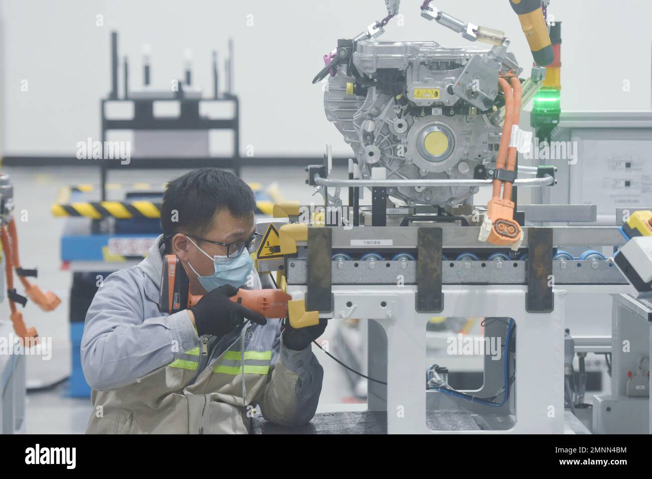 HANGZHOU, CHINA - JANUARY 31, 2023 - A worker produces a new three-in-one motor, one of the core systems for new energy vehicles, at a workshop of ZF Stock Photo