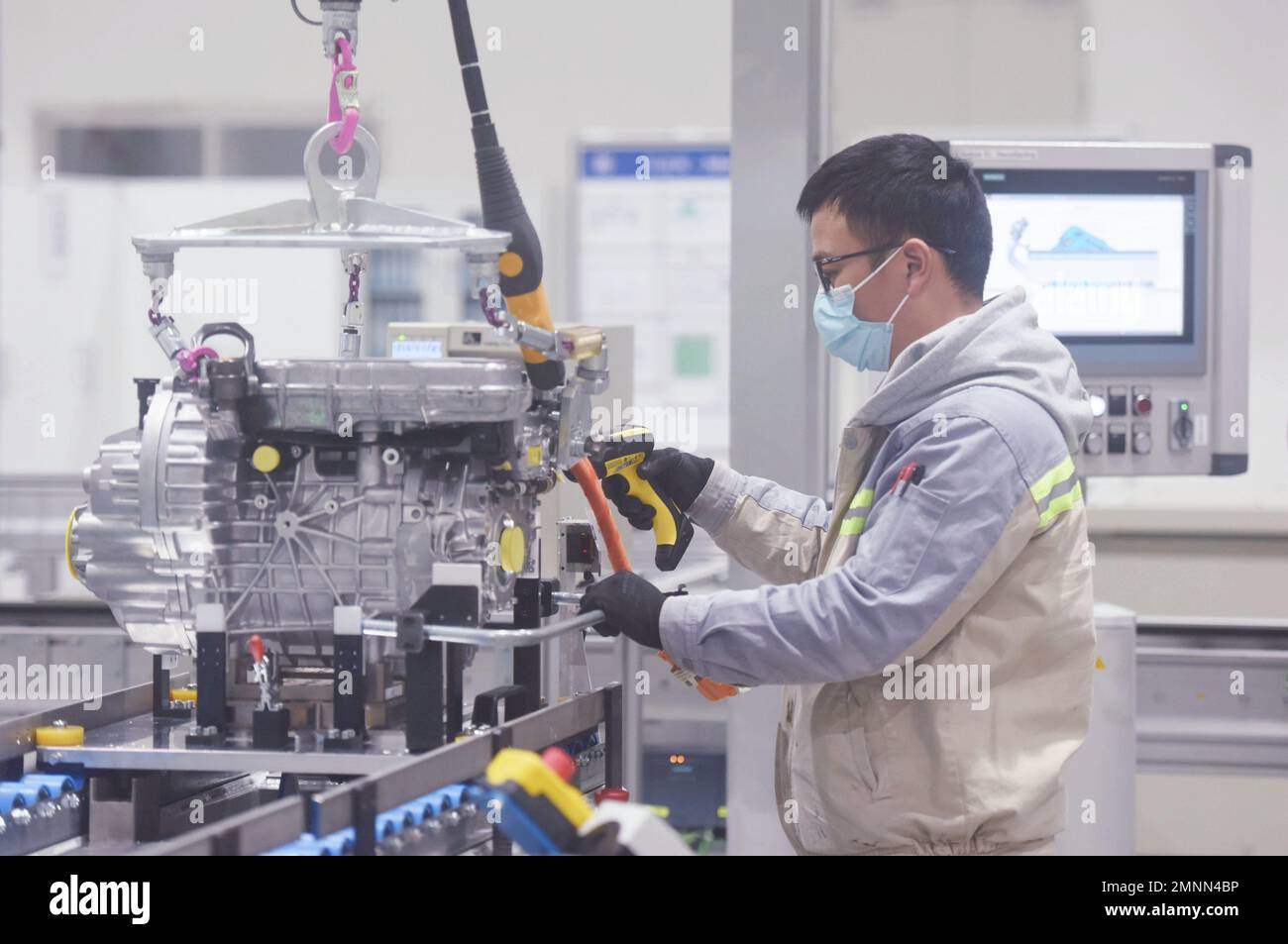HANGZHOU, CHINA - JANUARY 31, 2023 - A worker produces a new three-in-one motor, one of the core systems for new energy vehicles, at a workshop of ZF Stock Photo