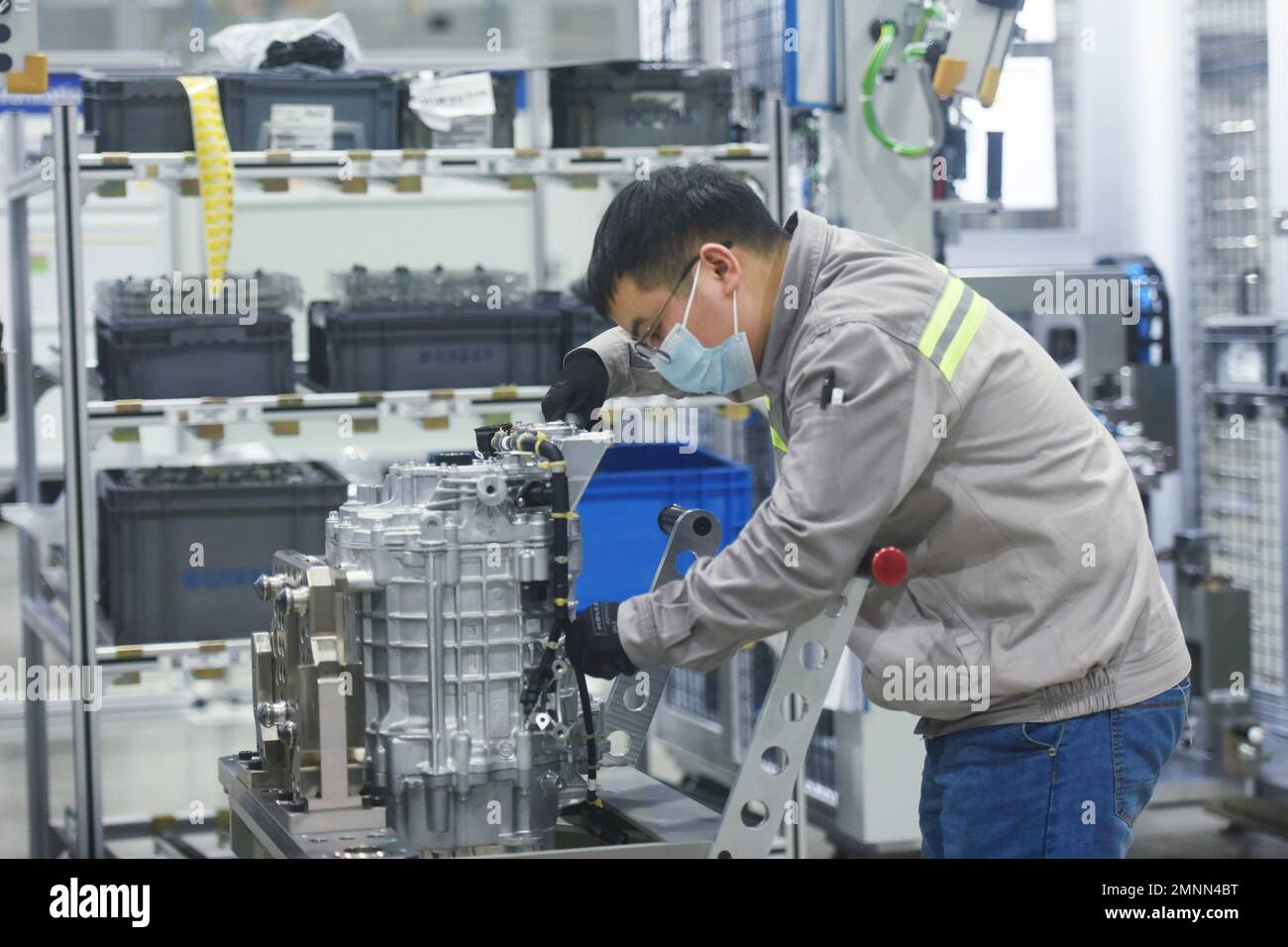 HANGZHOU, CHINA - JANUARY 31, 2023 - A worker produces a new three-in-one motor, one of the core systems for new energy vehicles, at a workshop of ZF Stock Photo