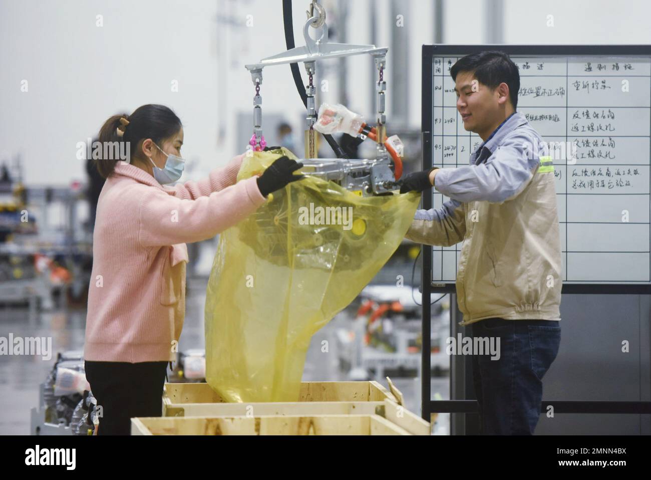 HANGZHOU, CHINA - JANUARY 31, 2023 - Workers pack a new three-in-one motor, one of the core systems of a new energy vehicle, at a workshop of ZF Elect Stock Photo