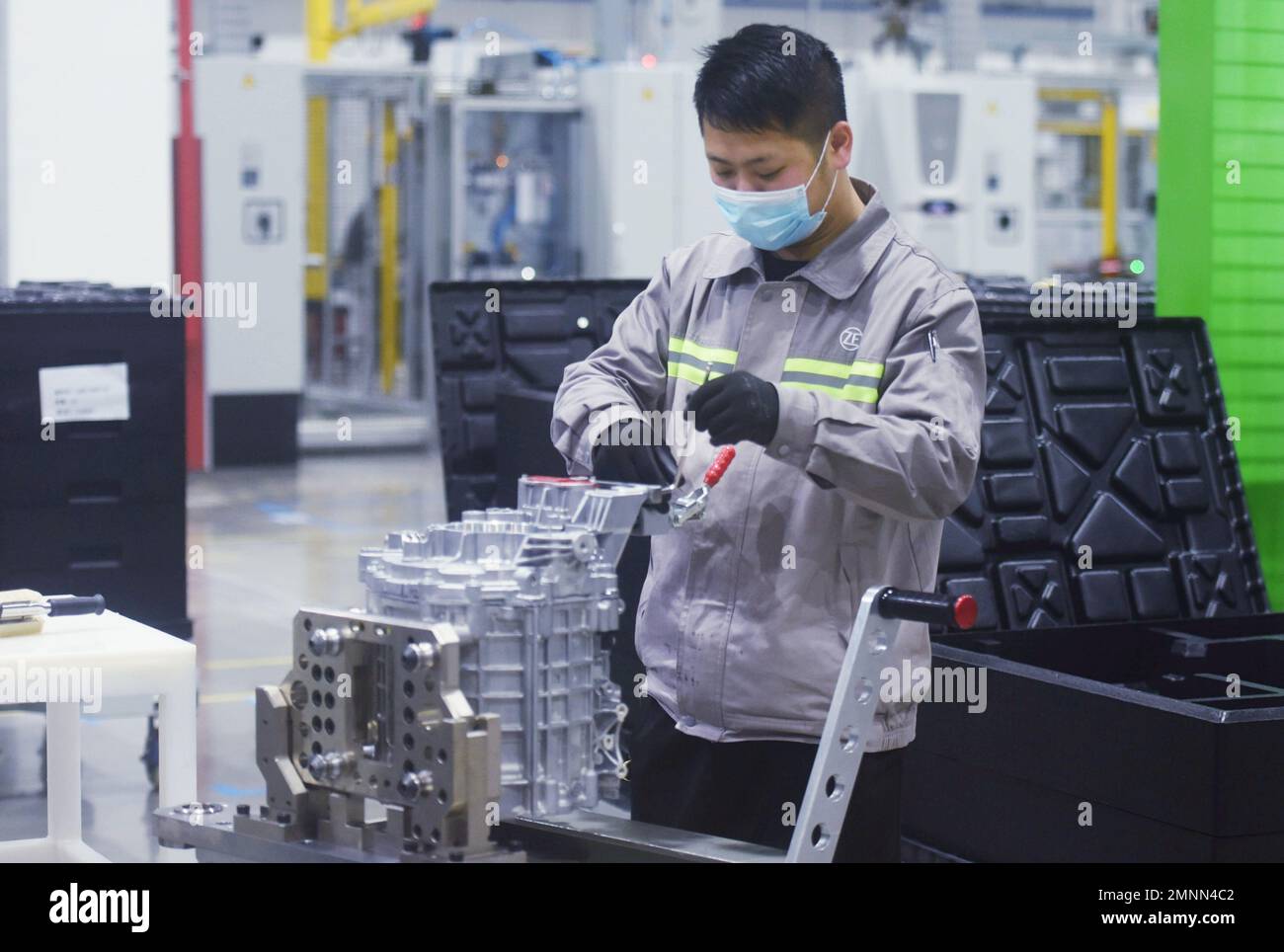 HANGZHOU, CHINA - JANUARY 31, 2023 - A worker produces a new three-in-one motor, one of the core systems for new energy vehicles, at a workshop of ZF Stock Photo