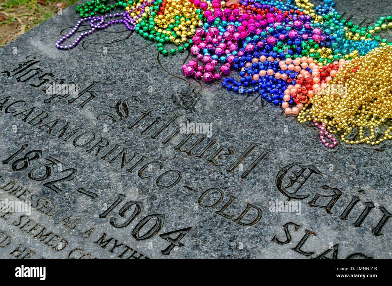 Mardi Gras beads are strewn across Joe Cain’s grave in Church Street Graveyard, Jan. 30, 2023, in Mobile, Alabama. Stock Photo