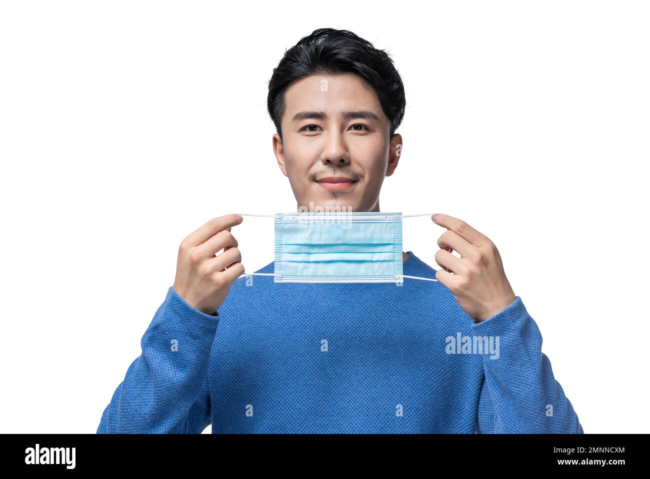 The young man holding a surgical mask Stock Photo Alamy