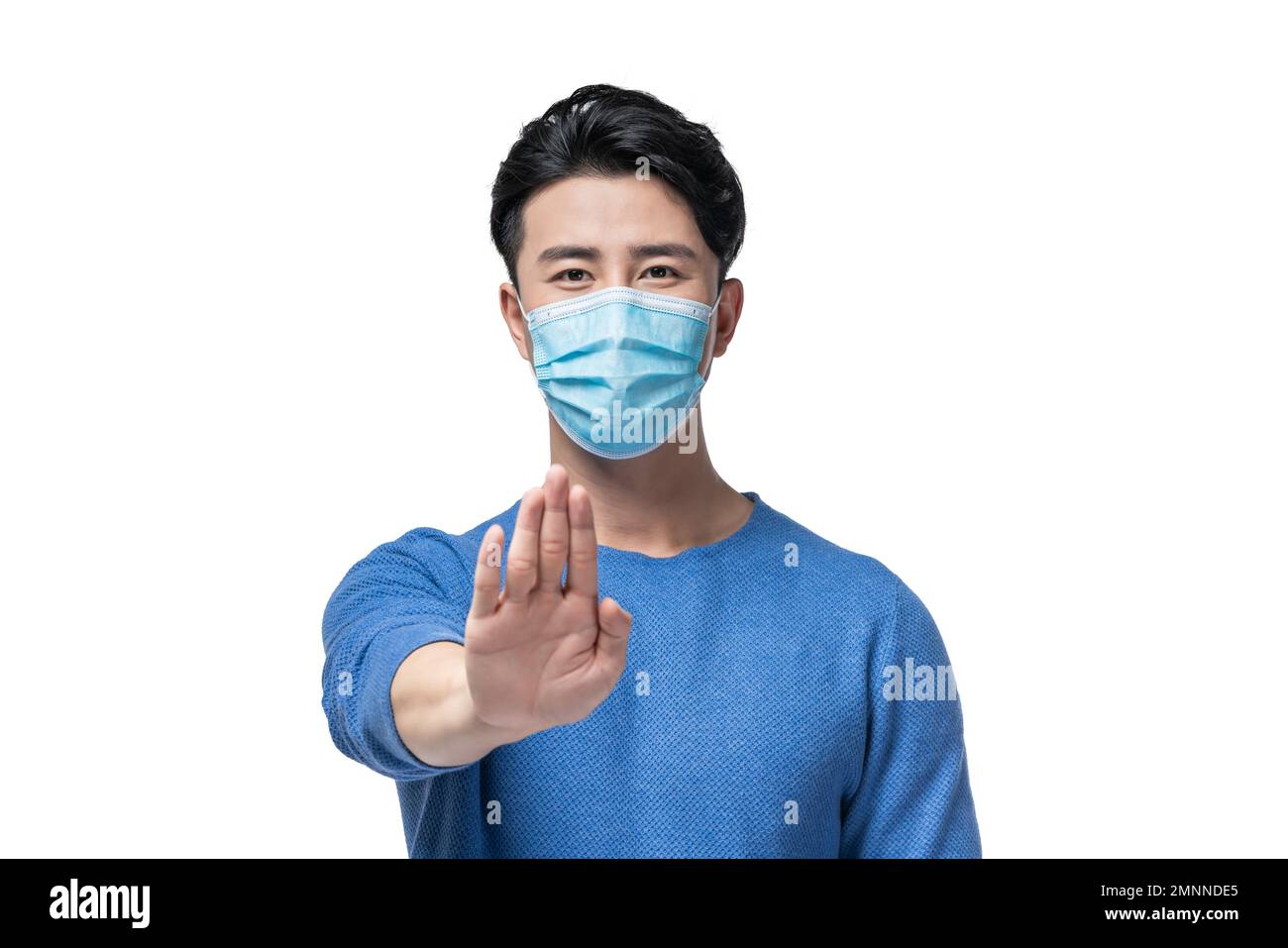 The young man holding a surgical mask Stock Photo - Alamy