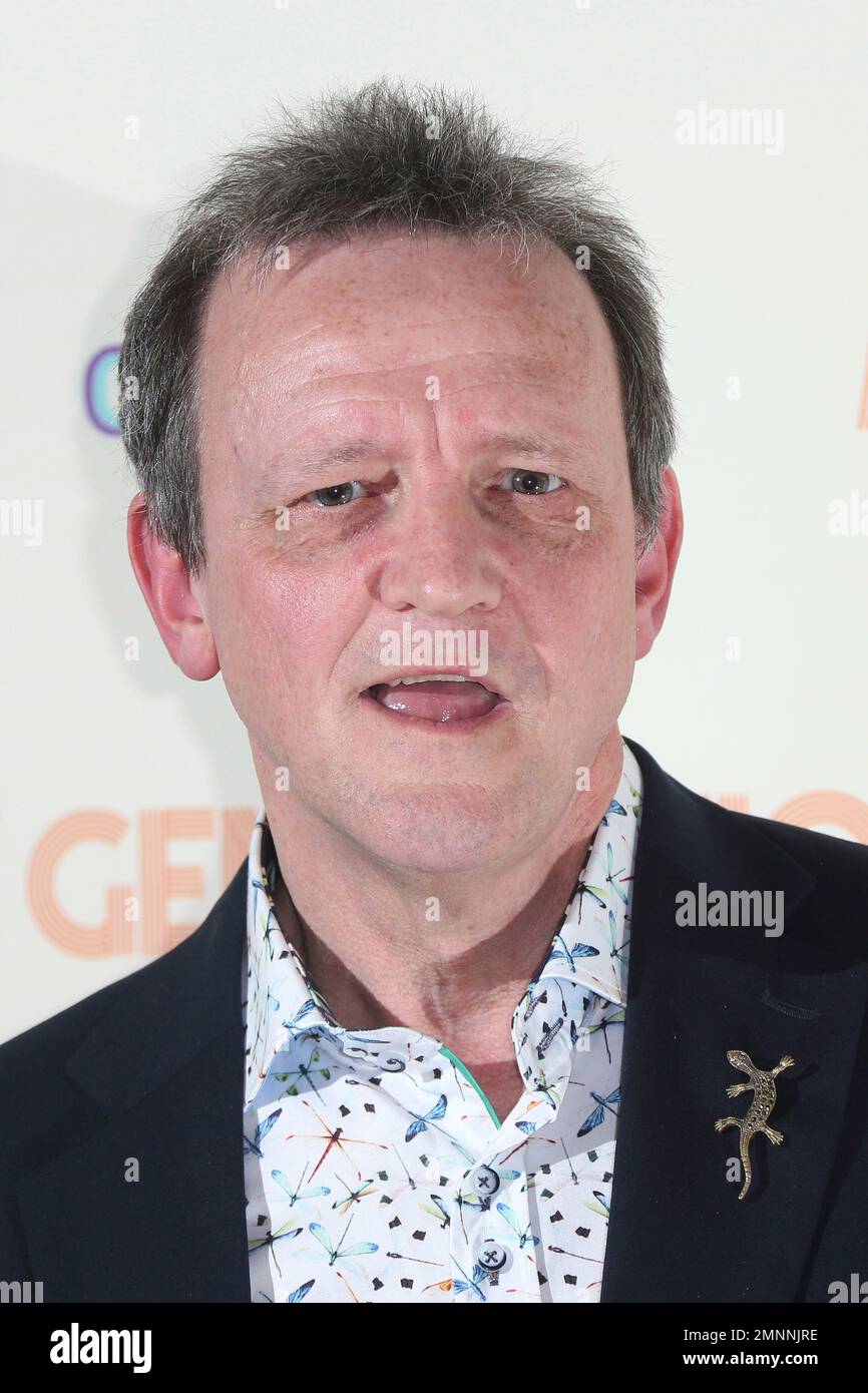 Director David Batty poses for photographers upon arrival at the