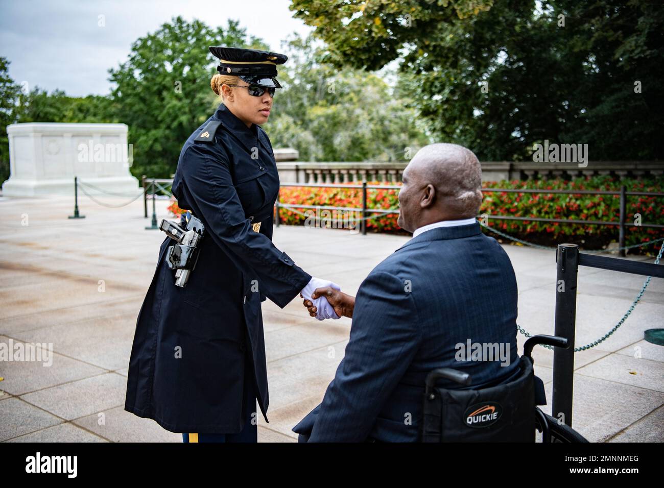 A sentinel from the 3d U.S. Infantry Regiment (The Old Guard) thanks U.S. Army Col. (ret.) Gregory Gadson for his participation in a Public Wreath-Laying Ceremony at the Tomb of the Unknown Soldier, Arlington National Cemetery, Arlington, Va., Oct. 4, 2022. Gadson was at ANC to speak to employees as part of the National Disability Employment Awareness Month. Gadson has dedicated himself to the work of Wounded Warriors, veterans, and other groups who support employment and betterment of person with disabilities. Stock Photo