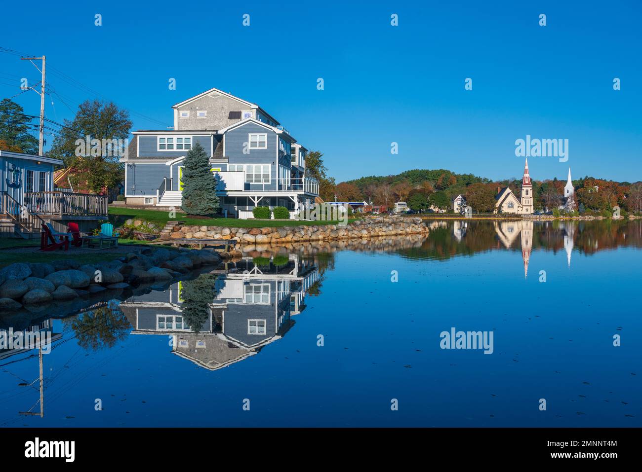 Reflections of churches with fall foliage color in Mahone Bay, Nova