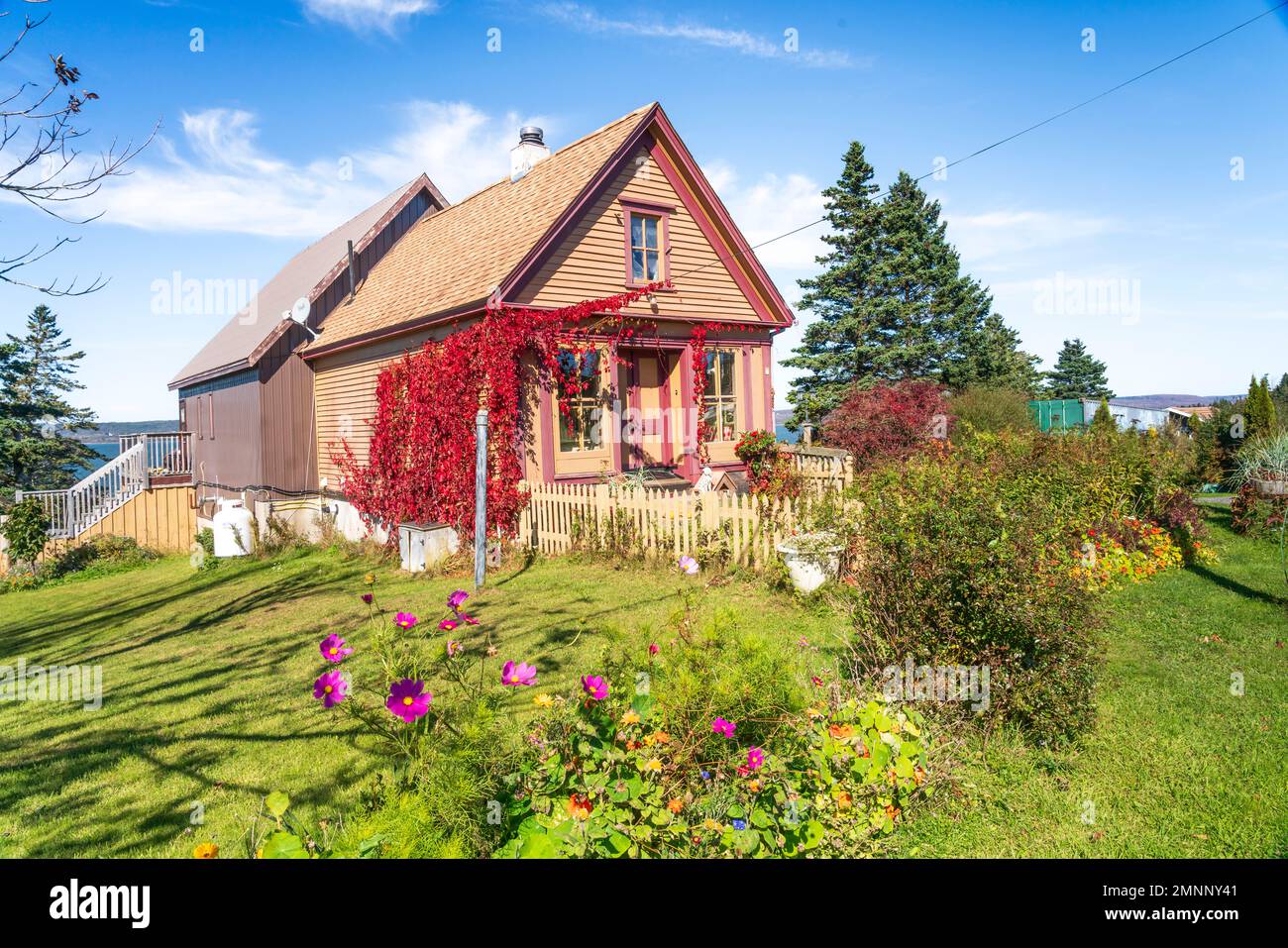 A small cottage with fall foliage color in Gilbert's Cove, Nova Scotia
