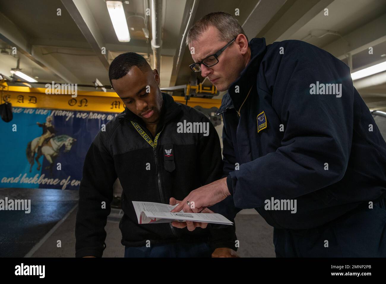 Chief Aviation Boatswain’s Mate (Handling) Jason M. Hausman, from Allentown, Pennsylvania, right