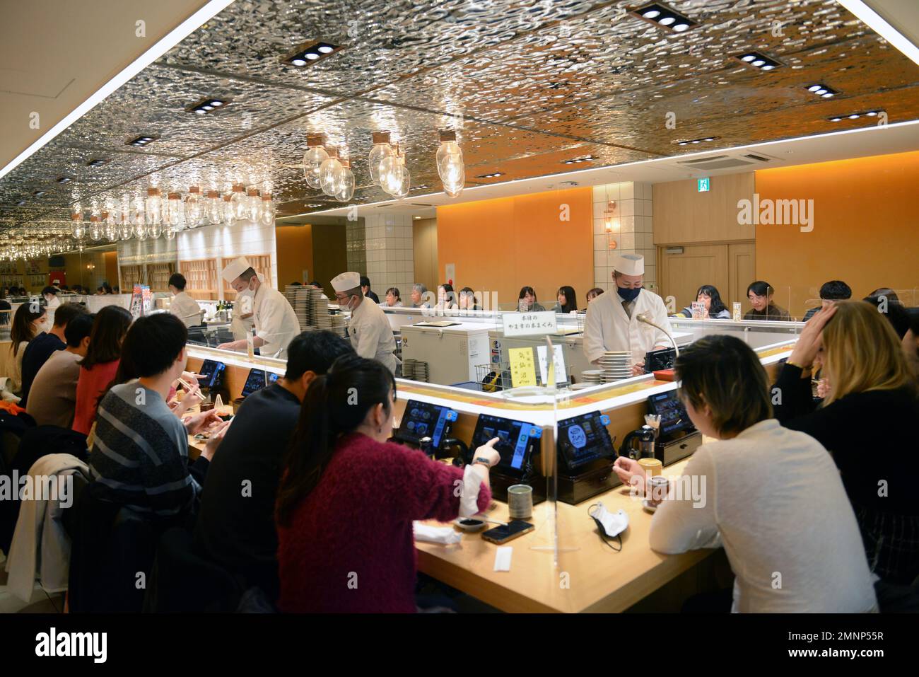 Sitting inside the Kaiten Sushi restaurant in Jingumae, Tokyo, Japan ...