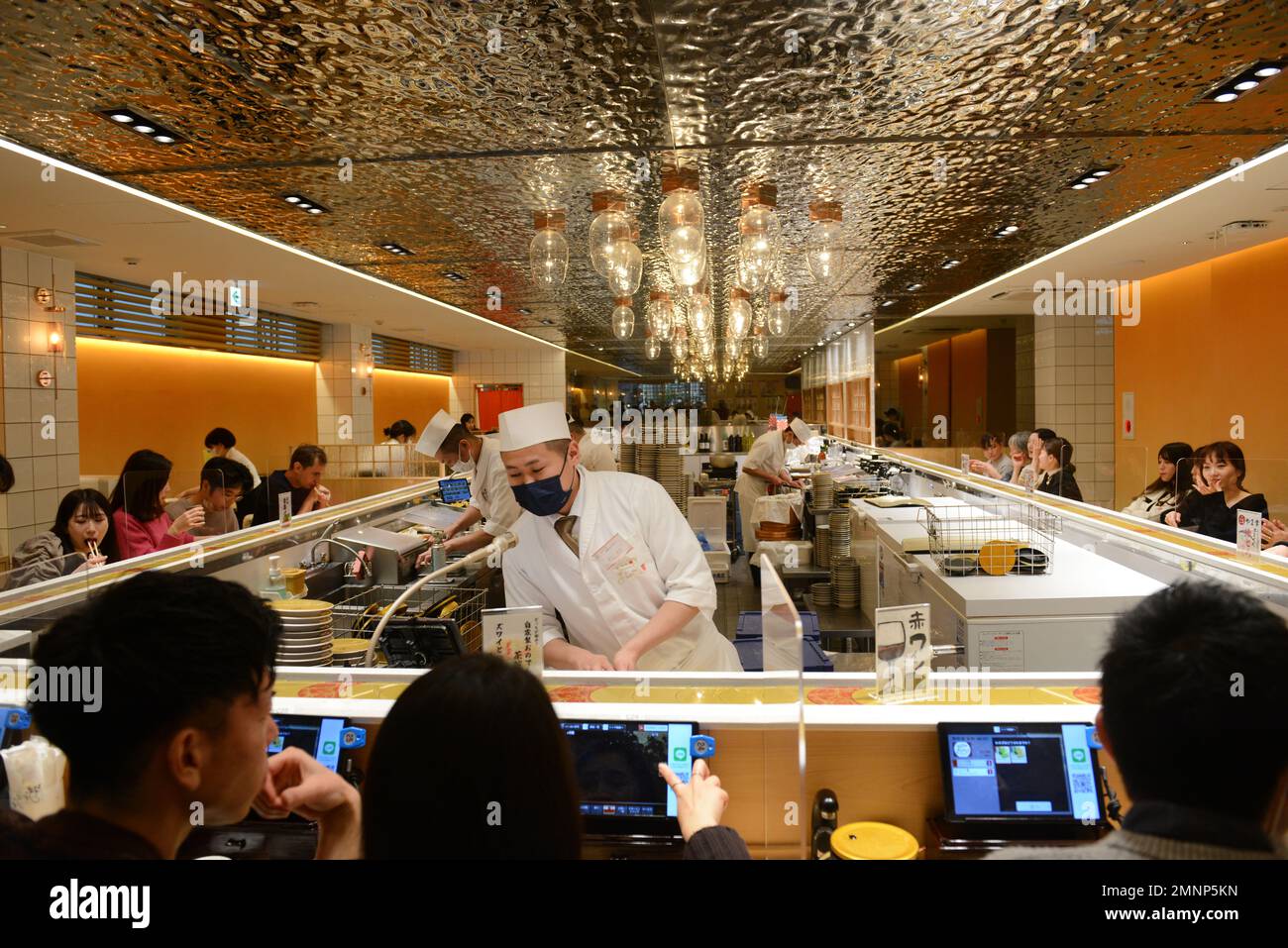 Sitting inside the Kaiten Sushi restaurant in Jingumae, Tokyo, Japan ...