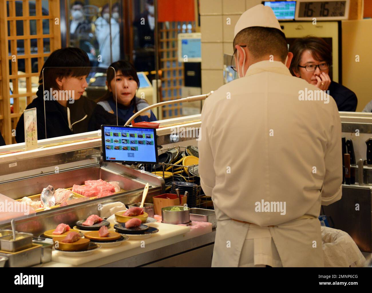Sitting inside the Kaiten Sushi restaurant in Jingumae, Tokyo, Japan ...