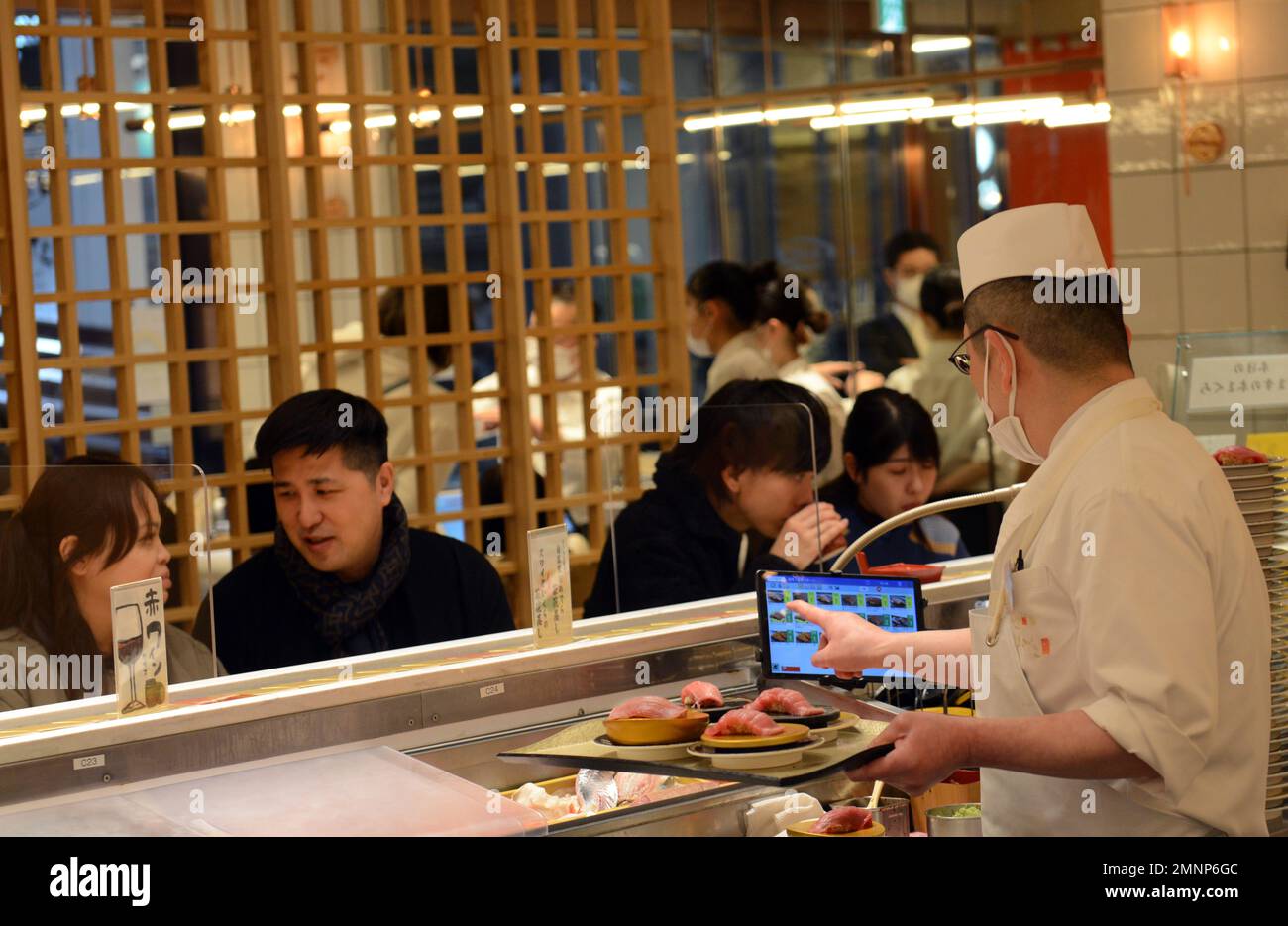 Sitting inside the Kaiten Sushi restaurant in Jingumae, Tokyo, Japan ...
