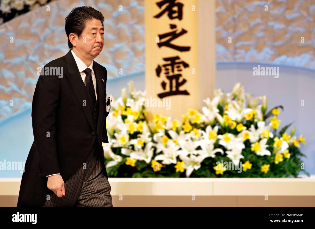 Japanese Prime Minister Shinzo Abe walks after praying in front of an ...