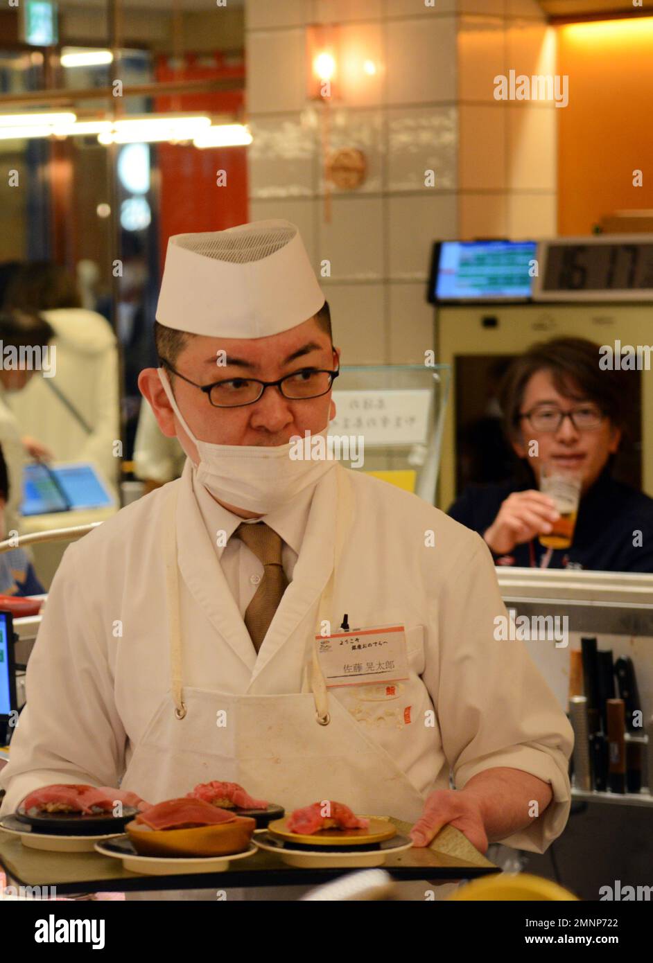 Sitting inside the Kaiten Sushi restaurant in Jingumae, Tokyo, Japan ...
