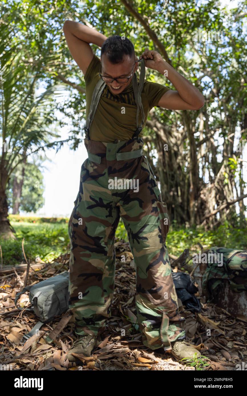 A Marine puts on mission-oriented protective posture gear at