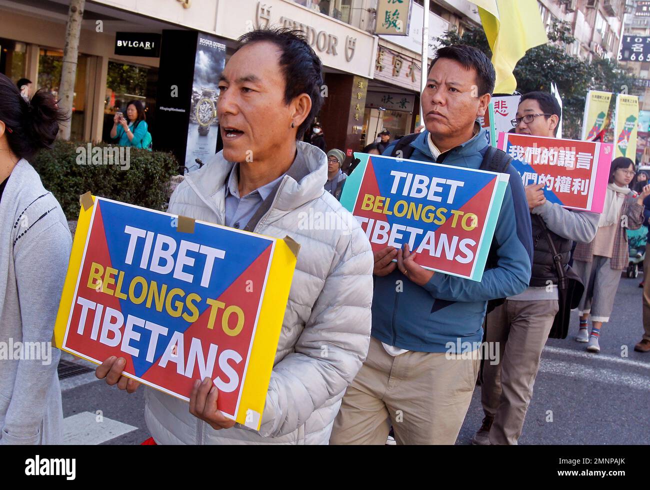 Tibetans living in Taiwan and their supporters shout slogans during a ...