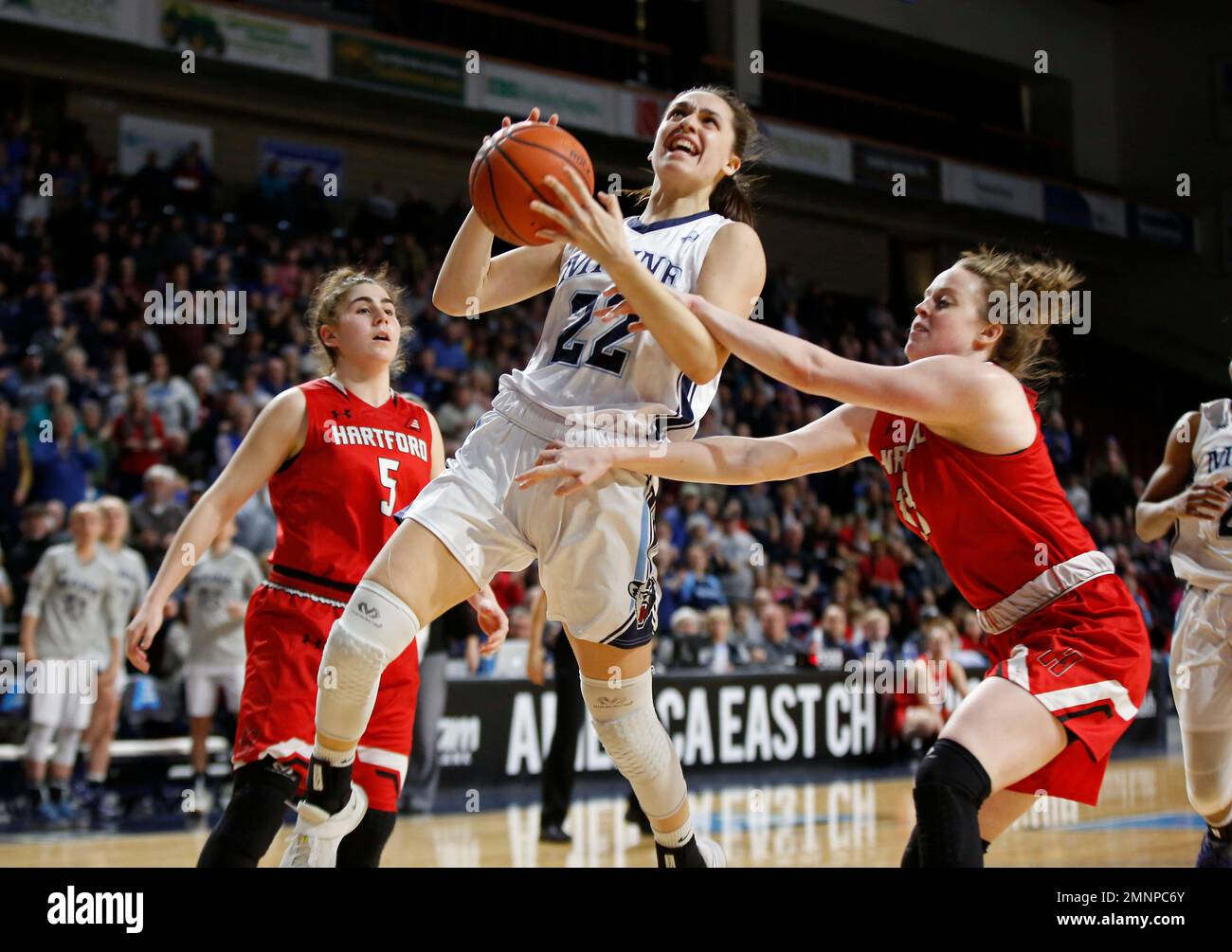 Maine's Blanca Millan, drives through Hartford's Lindsey Abed, left
