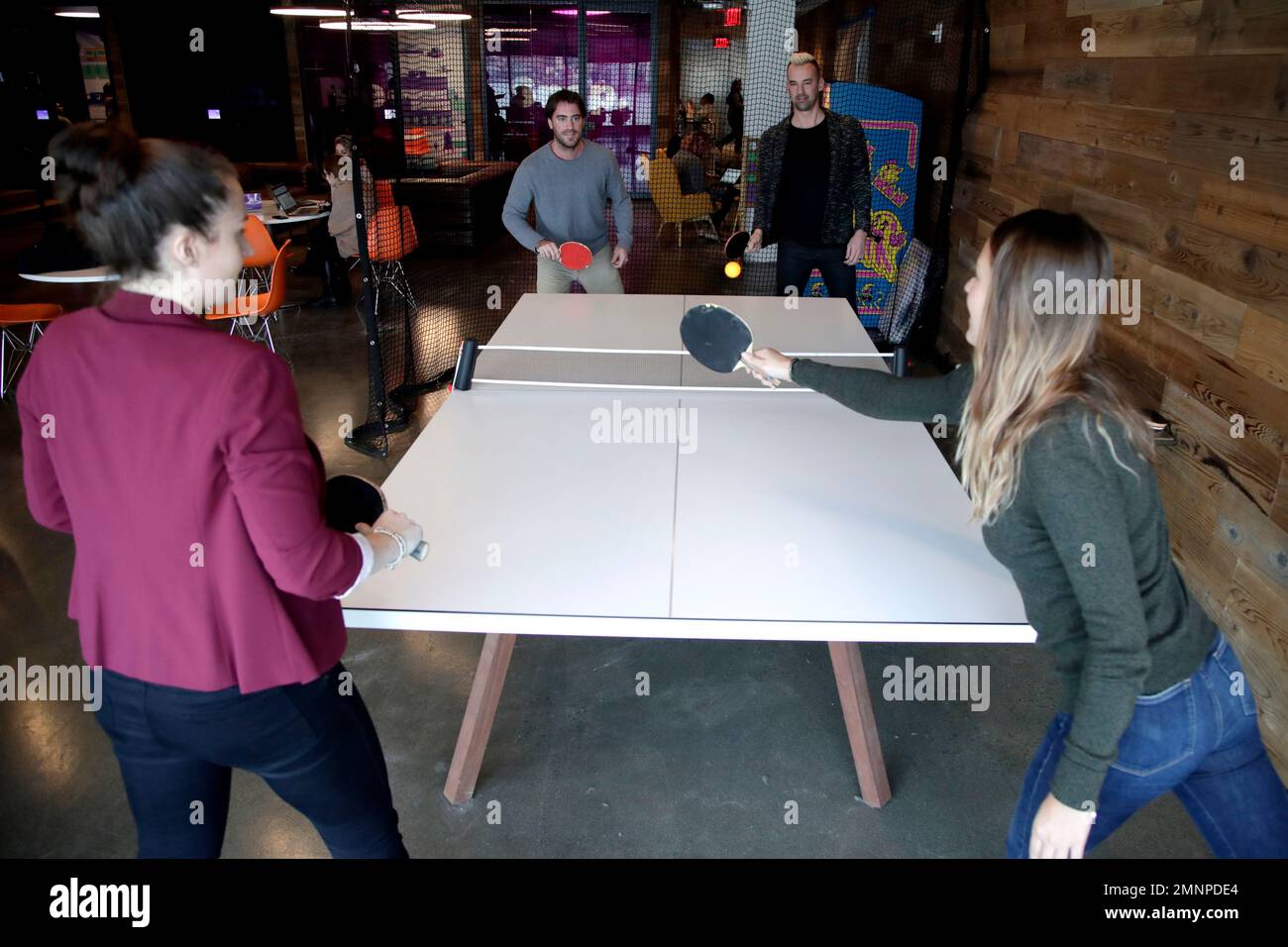 In this Jan. 23, 2018, photo, employees play table tennis