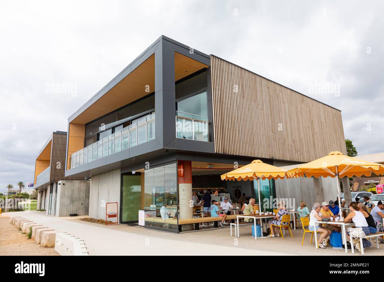 Mona Vale Surf Club building and adjacent coffee shop cafe with retired and elderly people enjoying drinks and food,Sydney,NSW,Australia Stock Photo