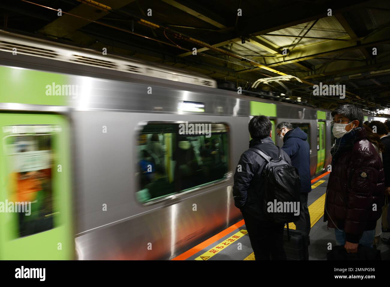 Japanese passengers waiting for the JR Yamanote line in Tokyo, Japan