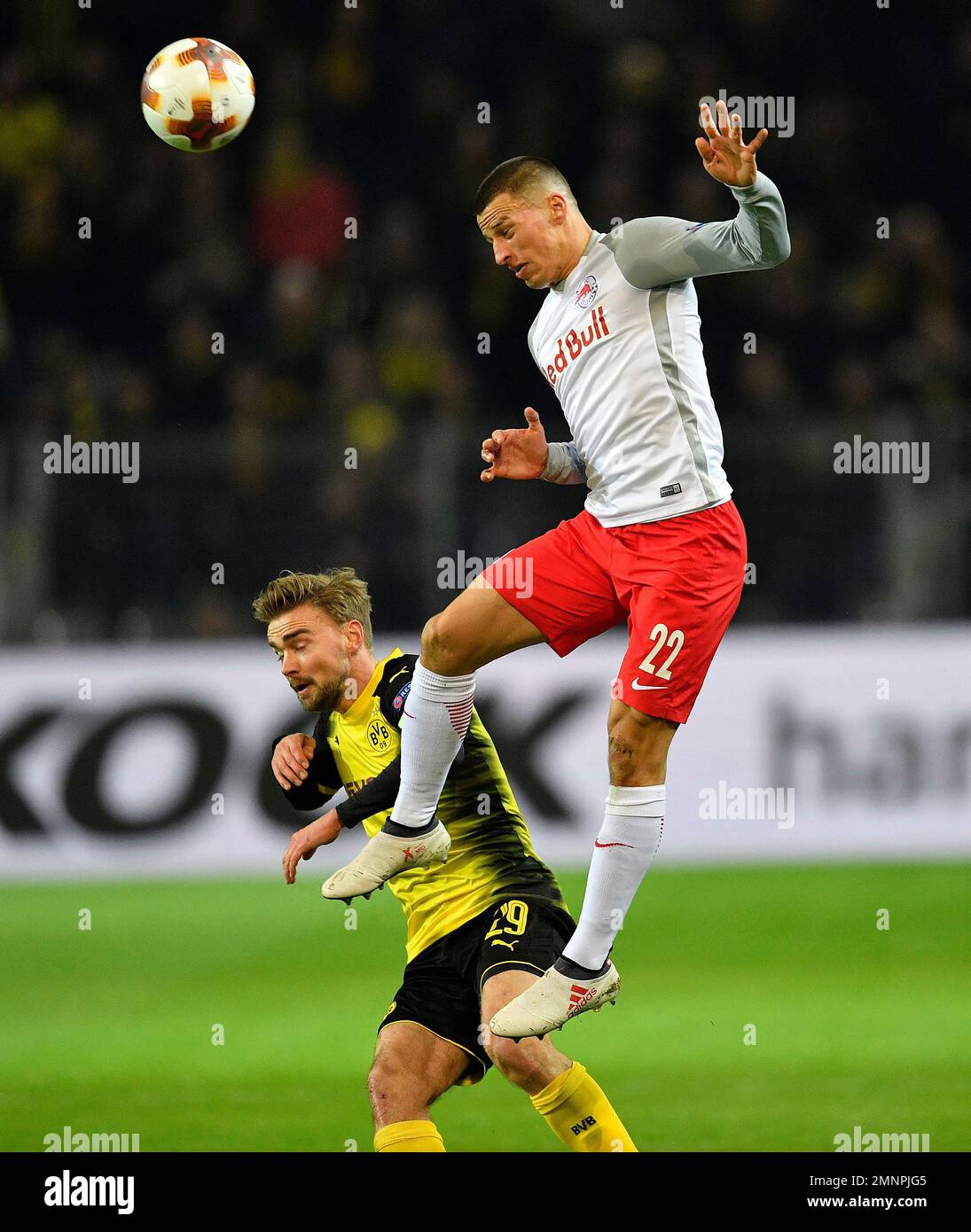 Salzburg's Stefan Lainer, up, and Dortmund's Marcel Schmelzer challenge for  the ball during the Europa League soccer match between Borussia Dortmund  and FC Salzburg in Dortmund, Germany, Thursday, March 8, 2018. (AP
