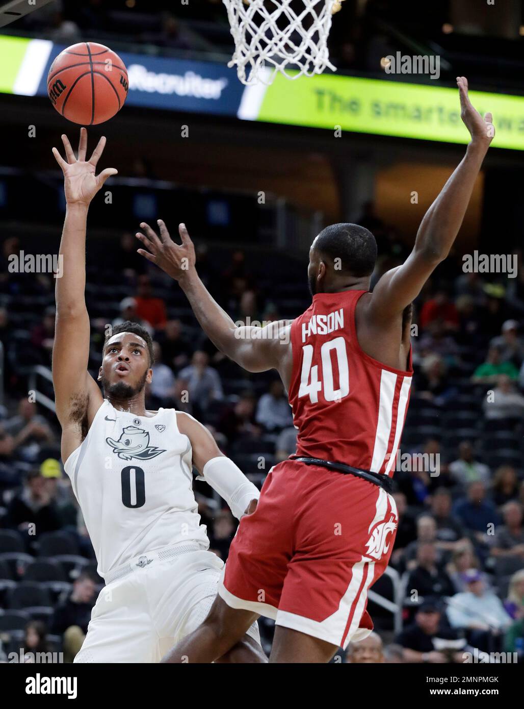 Oregon's Troy Brown, left, shoots while covered by Washington