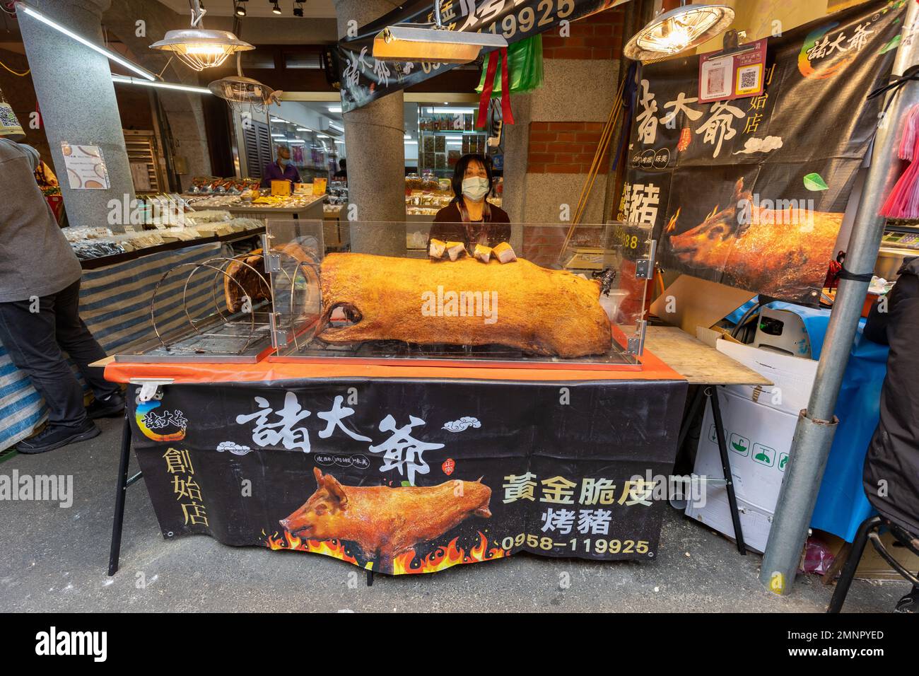 Selling crispy pig skin at the Dihua St New Year's market in Taipei, Taiwan. Stock Photo