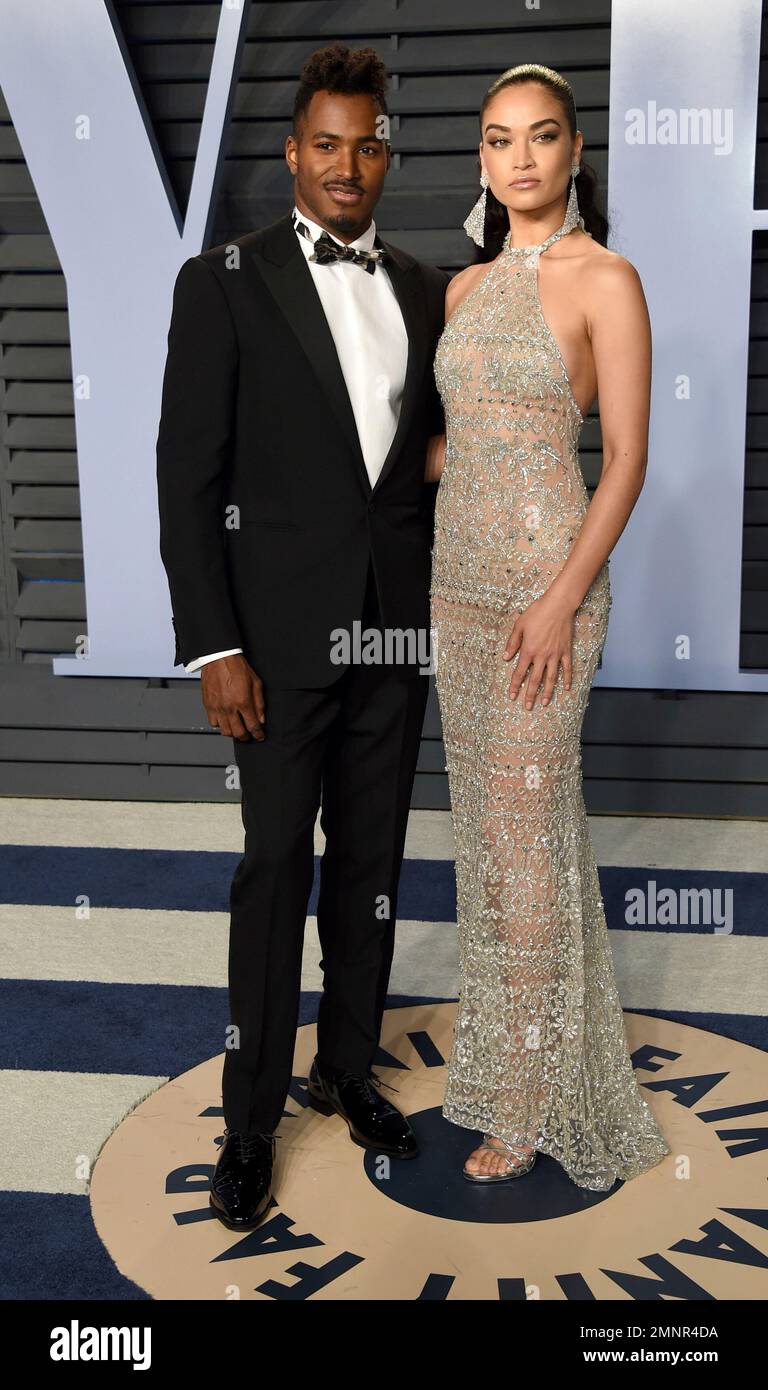 DJ Ruckus, left, and Shanina Shaik arrive at the Vanity Fair Oscar