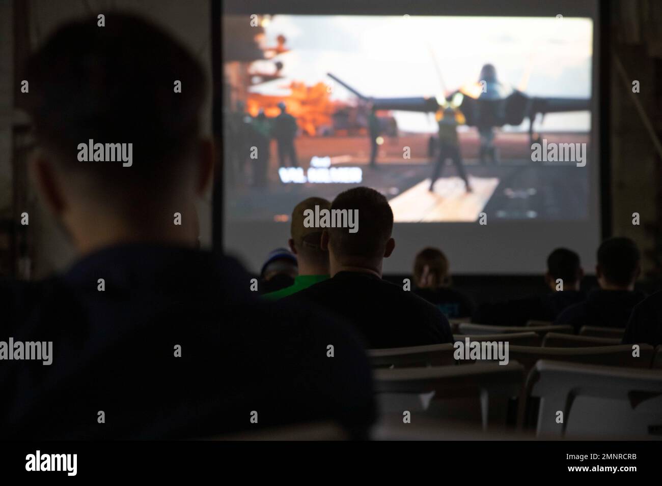 Sailors aboard the Nimitz-class aircraft carrier USS George Washington (CVN 73) attend a movie screening aboard the ship in Newport News, Virginia, Oct. 5, 2022. George Washington is conducting a simulated underway to validate shipboard habitability and operational services to ensure the ship meets the final refueling and complex overhaul (RCOH) milestones. RCOH is a multi-year project performed only once during a carrier’s 50-year service life that includes refueling the ship’s two nuclear reactors, as well as significant repairs, upgrades, and modernization. Stock Photo