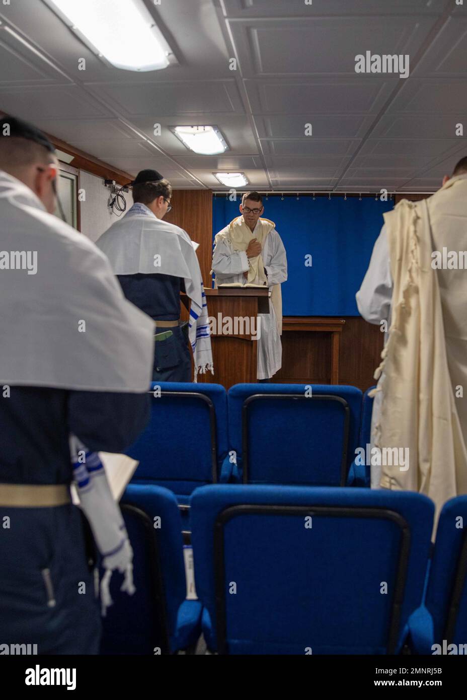 U.S. Navy Chaplain Rabbi Lt. Cmdr. Yonatan Warren, middle, from Norfolk, Virginia, joined the crew of the first-in-class aircraft carrier USS Gerald R. Ford (CVN 78) to celebrate the Jewish High Holy days and conduct Yom Kippur services in the ship’s chapel, Oct. 5, 2022. The Gerald R. Ford Carrier Strike Group (GRFCSG) is deployed in the Atlantic Ocean, conducting training and operations alongside NATO Allies and partners to enhance integration for future operations and demonstrate the U.S. Navy’s commitment to a peaceful, stable and conflict-free Atlantic region. Stock Photo
