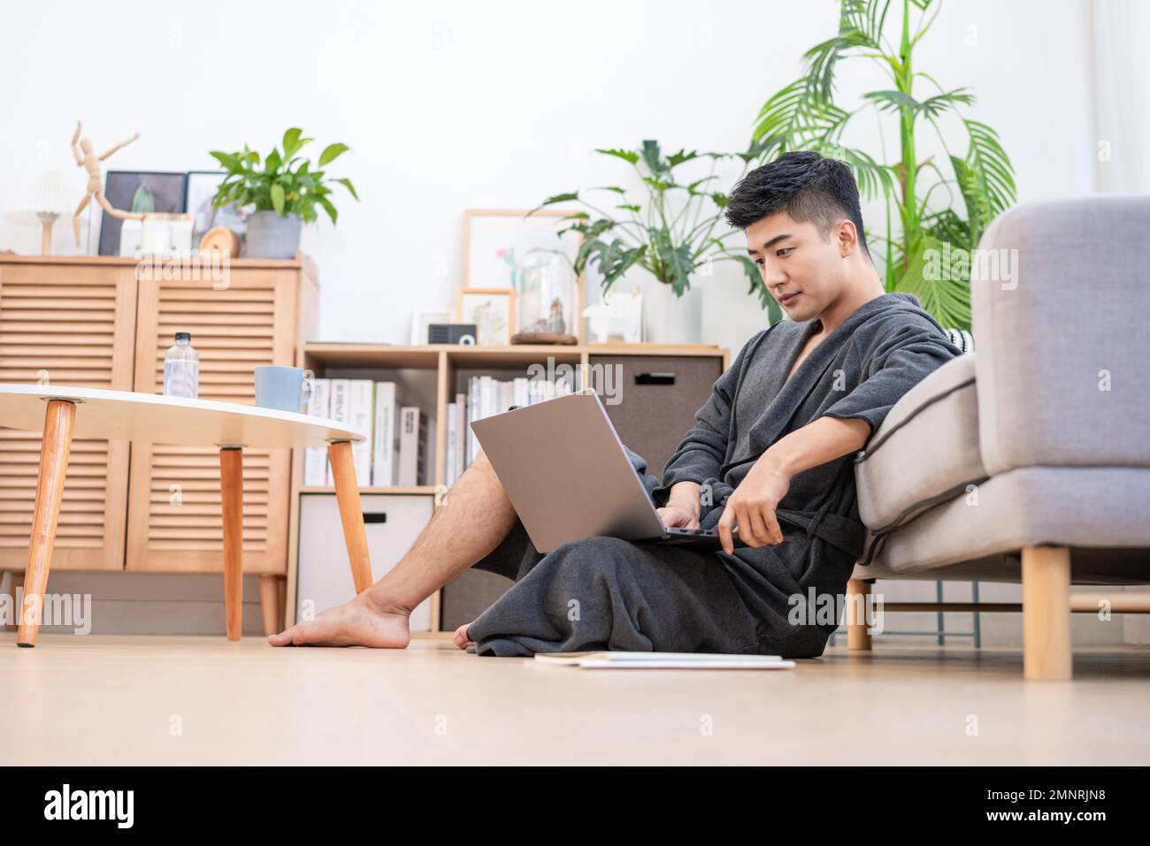 The young man to use a computer at home Stock Photo - Alamy