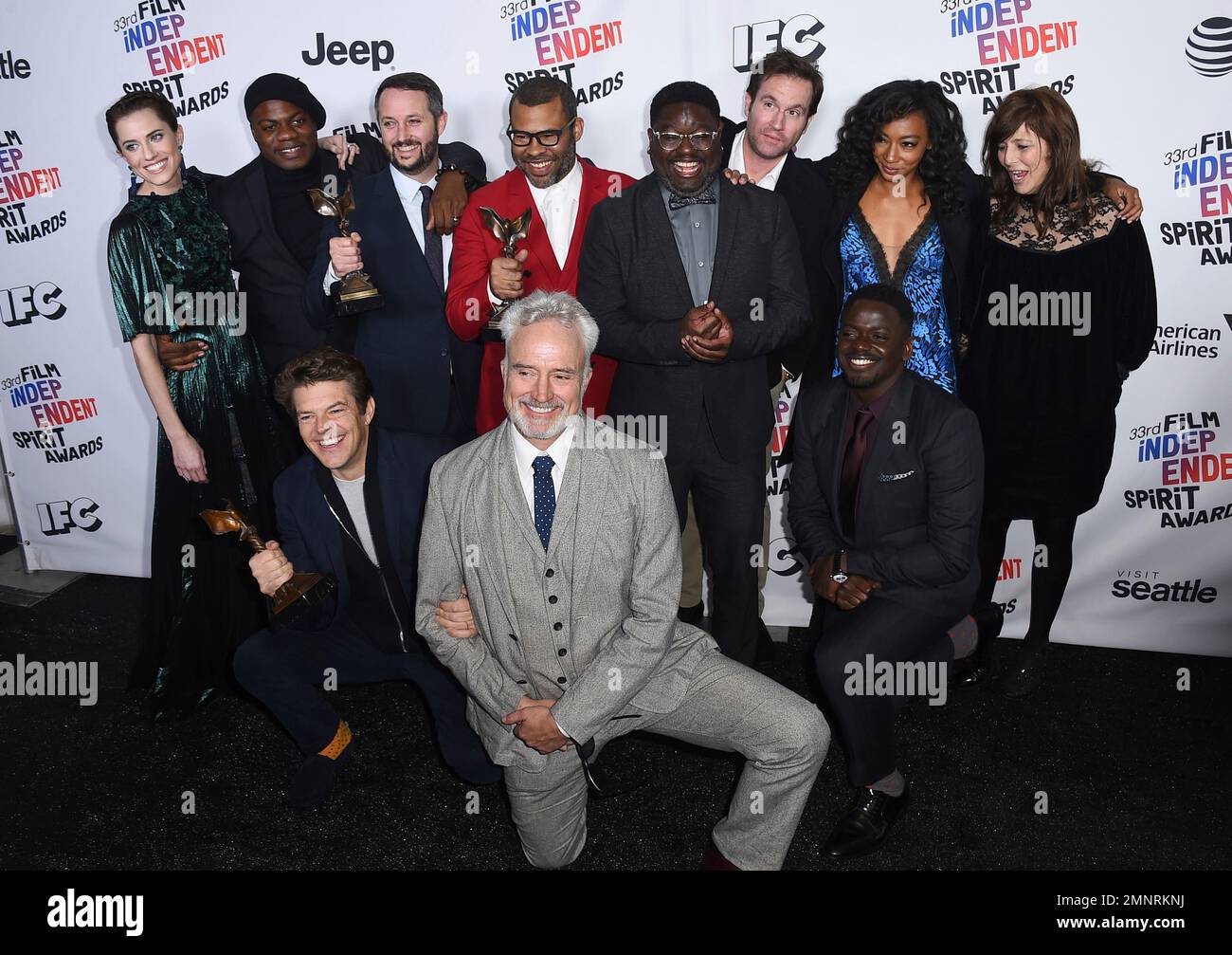 The cast and crew of &ldquo;Get Out&rdquo; pose in the press room with their awards