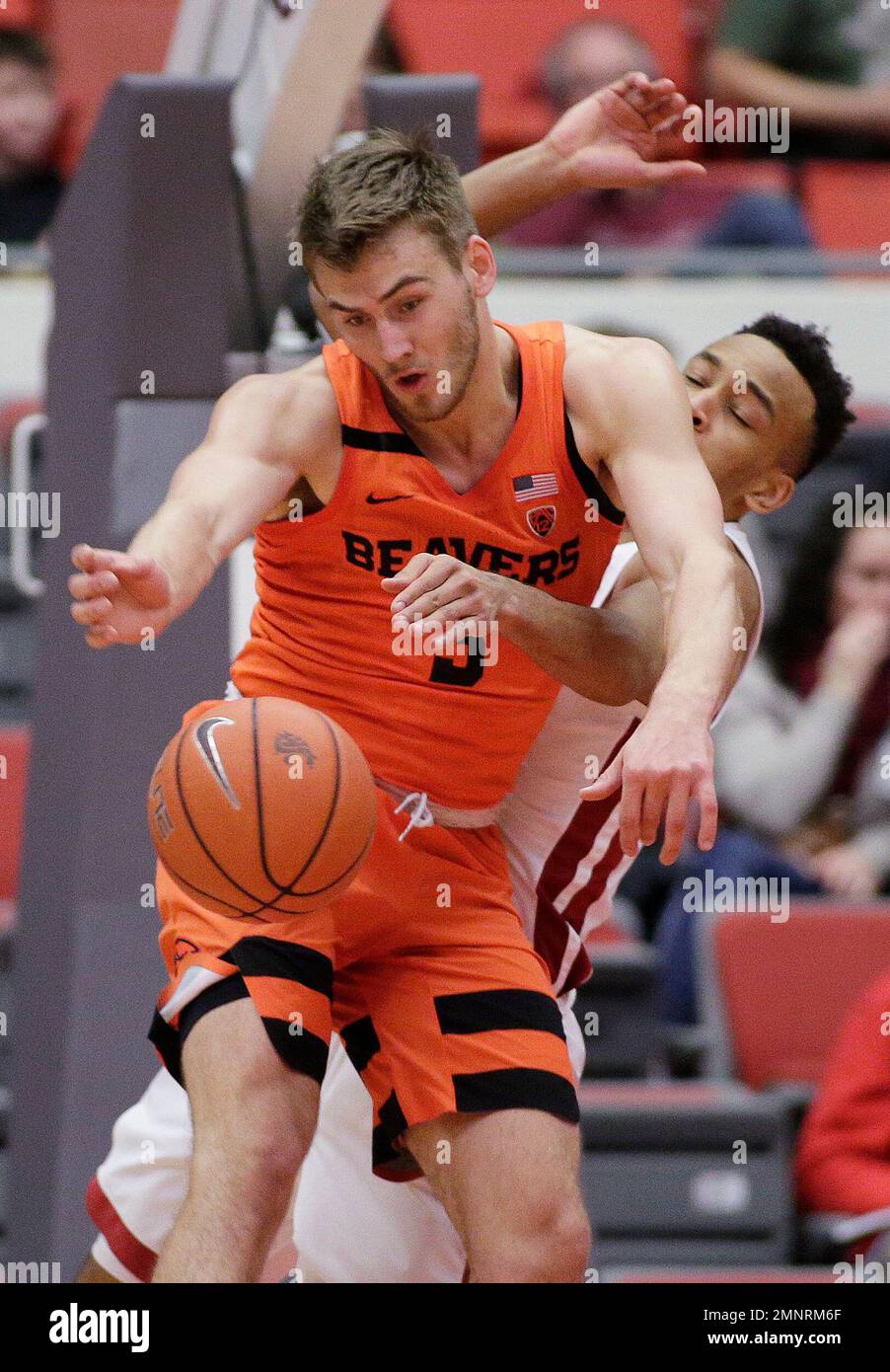 Oregon State forward Tres Tinkle, left, and Washington State forward