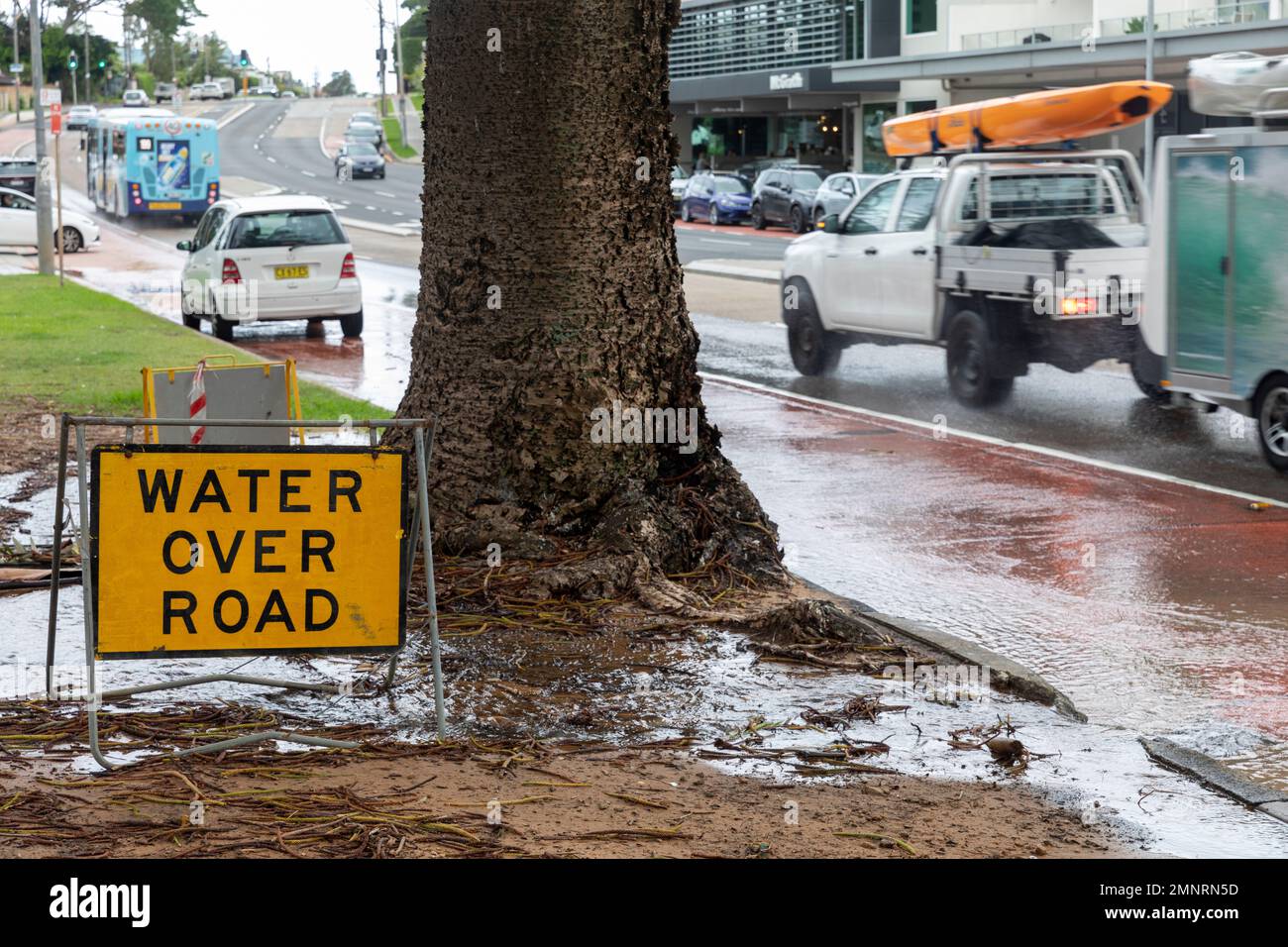 Water leak in pavement with water running over the road,Sydney,NSW,Australia Stock Photo