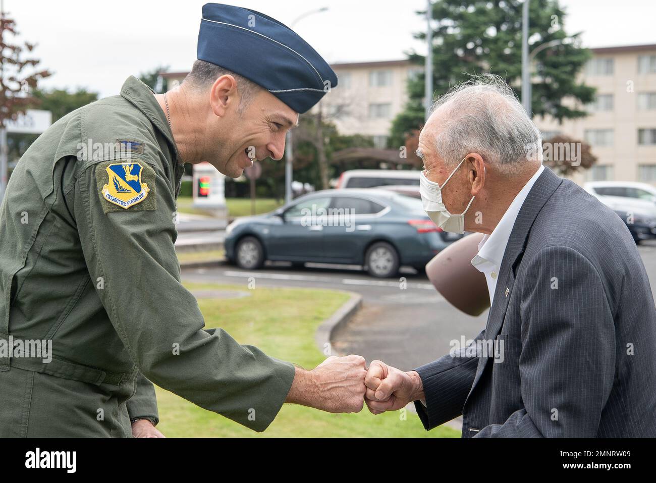 Col. Andrew Roddan, 374th Airlift Wing commander, bumps fists with a ...