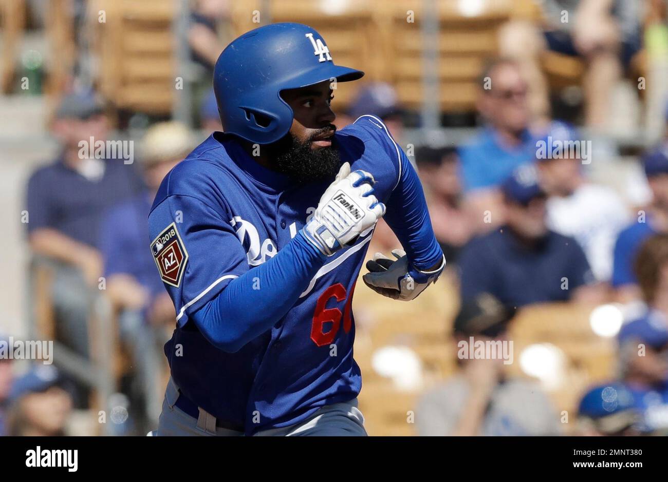 Los Angeles Dodgers' Andrew Toles runs to first during the second nning of  a spring training baseball game against the Chicago White Sox, Friday,  March 2, 2018, in Glendale, Ariz. (AP Photo/Carlos